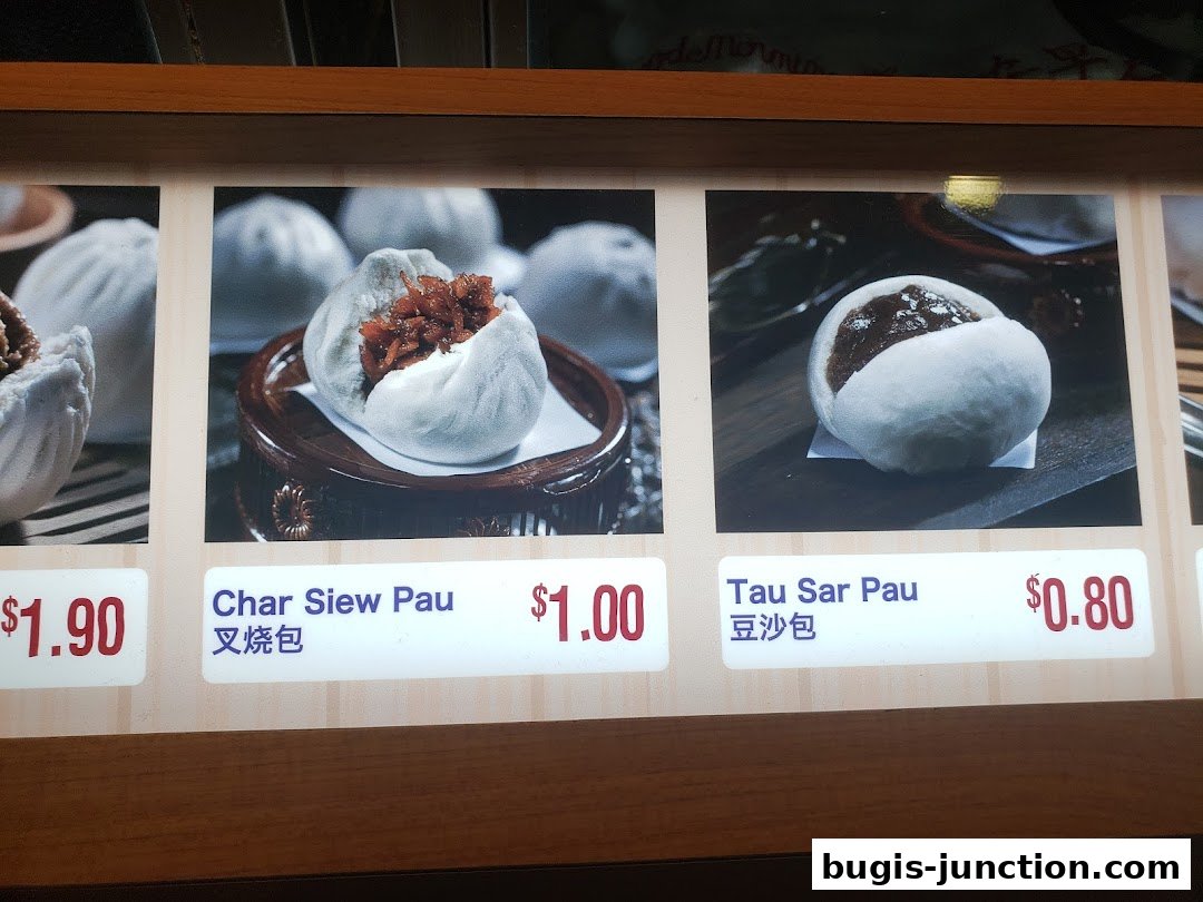 A close-up of a menu displaying two types of steamed buns with prices.