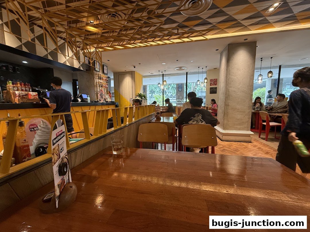 Interior view of a Nandos restaurant with customers dining and staff at the counter.