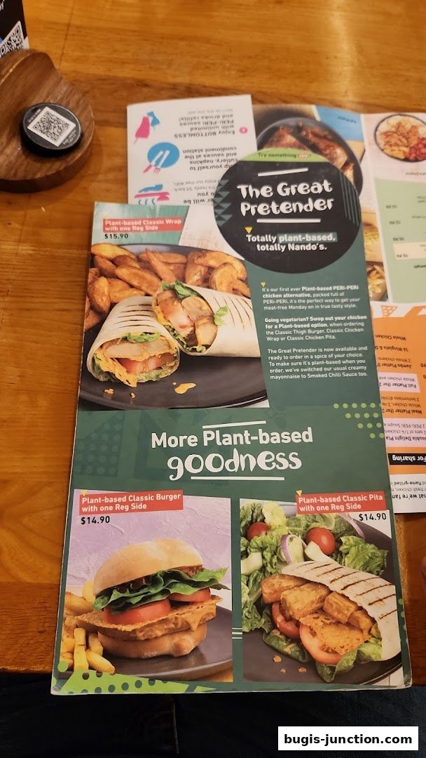A Nando's menu featuring plant-based options like wraps, burgers, and pitas.