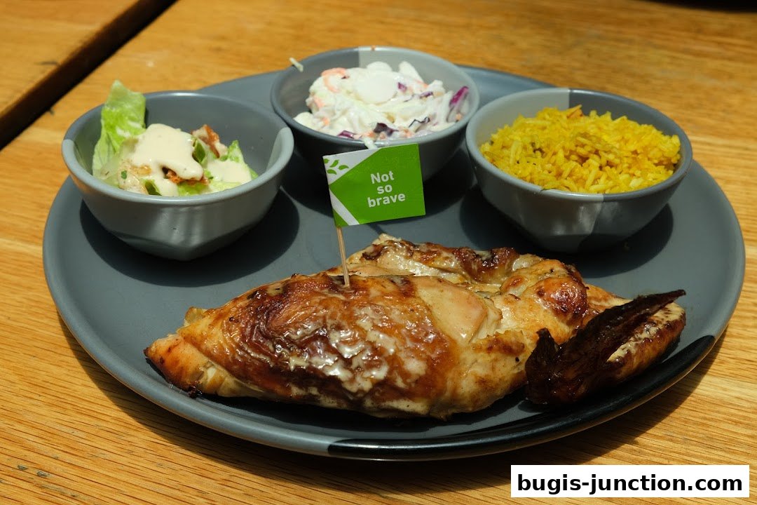 A plate of flame-grilled chicken with sides of salad, coleslaw, and rice.