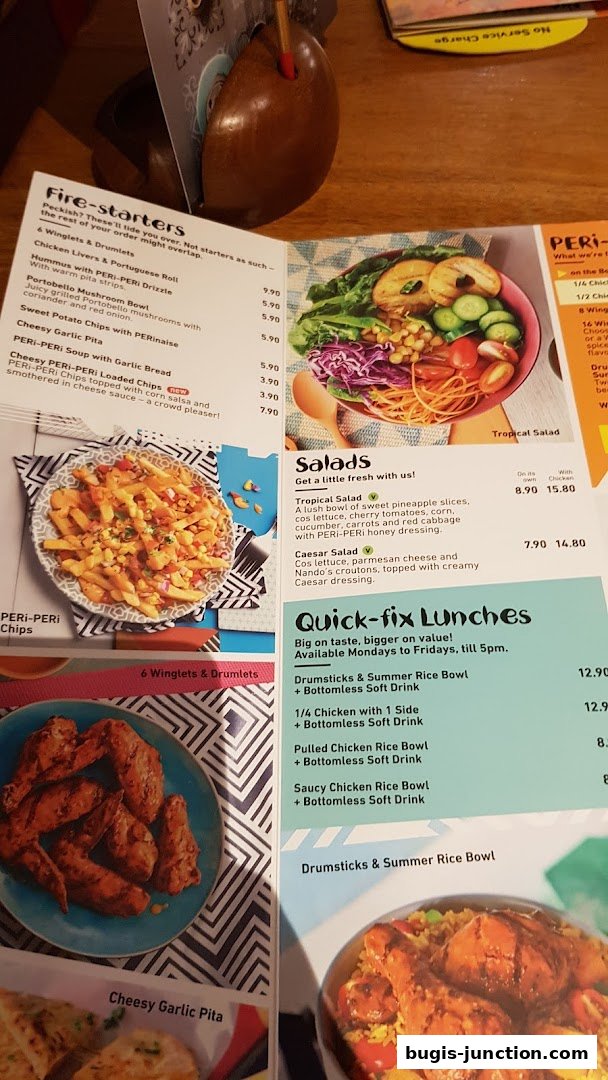 A menu from Nandos featuring fire-starters, salads, and quick-fix lunches with vibrant food photography.