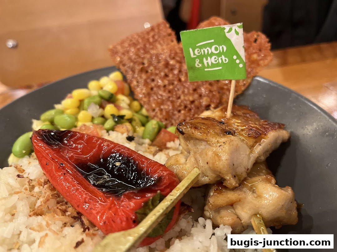 A close-up of a delicious Nandos meal with grilled chicken, rice, and vegetables.