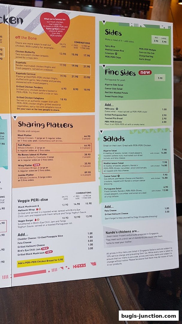 A menu from Nandos Bugis Junction featuring chicken dishes, sides, salads, and platters.