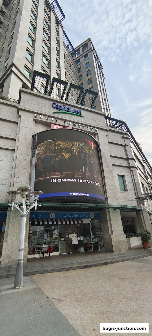 The exterior of a pancake cafe with a movie advertisement displayed above.