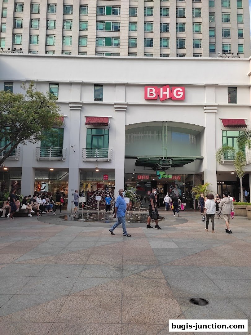 The exterior of the BHG department store at Bugis Junction with people walking by.
