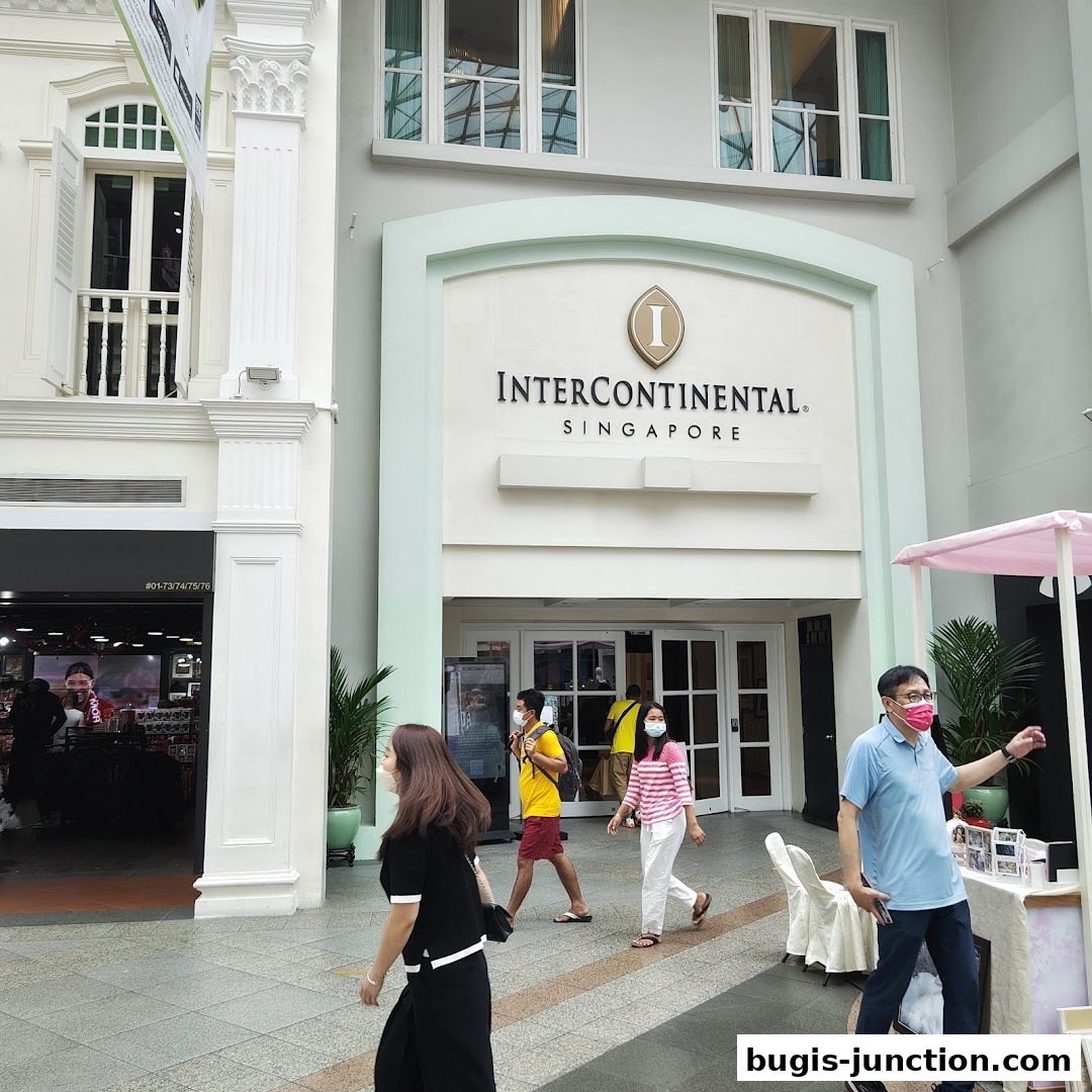 People walk past the entrance of the InterContinental Singapore hotel.