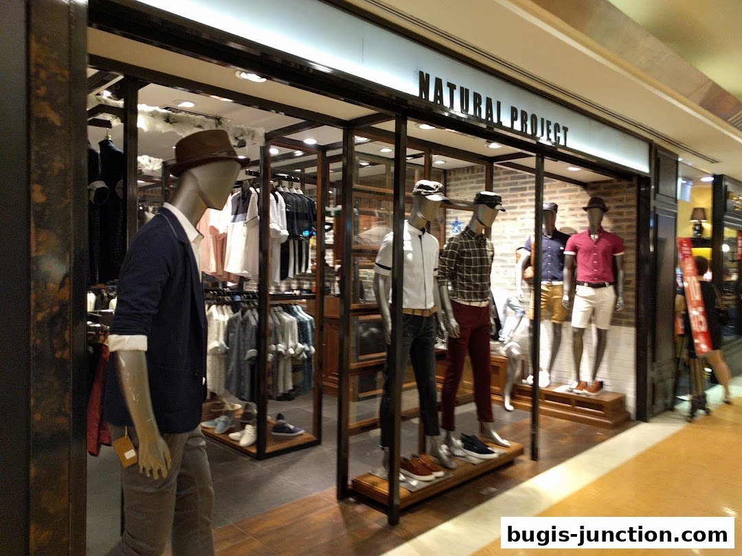 Mannequins dressed in stylish casual wear displayed in a modern retail store.
