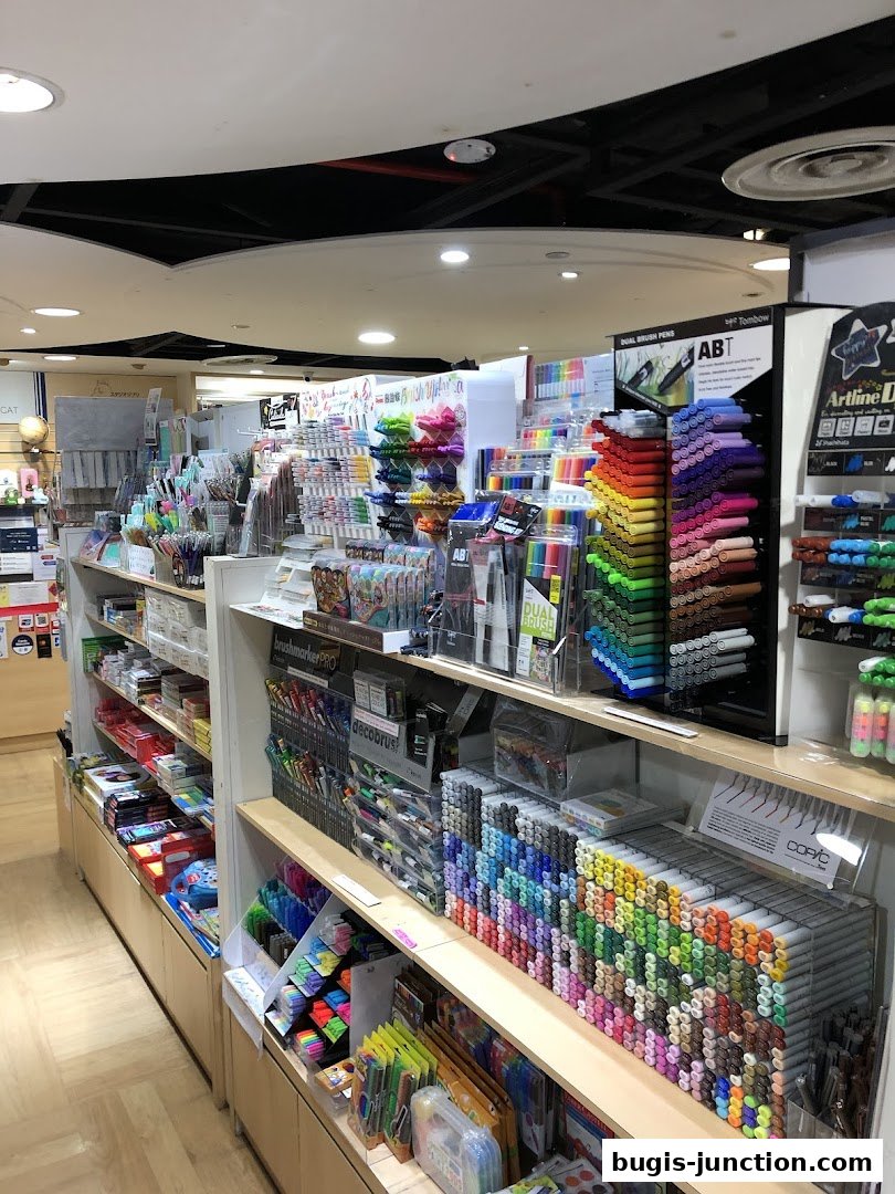 Interior view of a stationery shop showcasing a wide variety of colorful pens and art supplies.