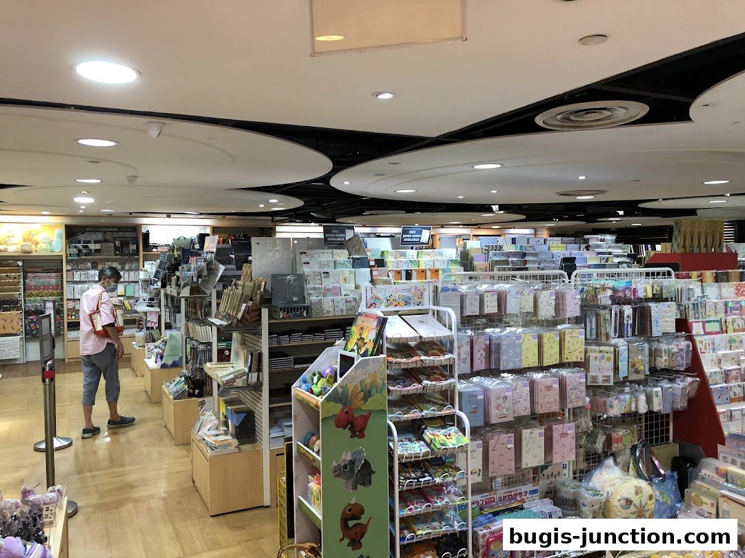 Interior view of a stationery and gift shop with shelves stocked with various products.