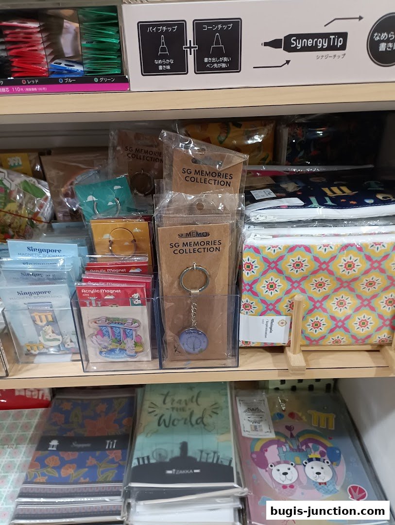 Shelves stocked with stationery, keychains, notebooks, and pouches featuring various designs.