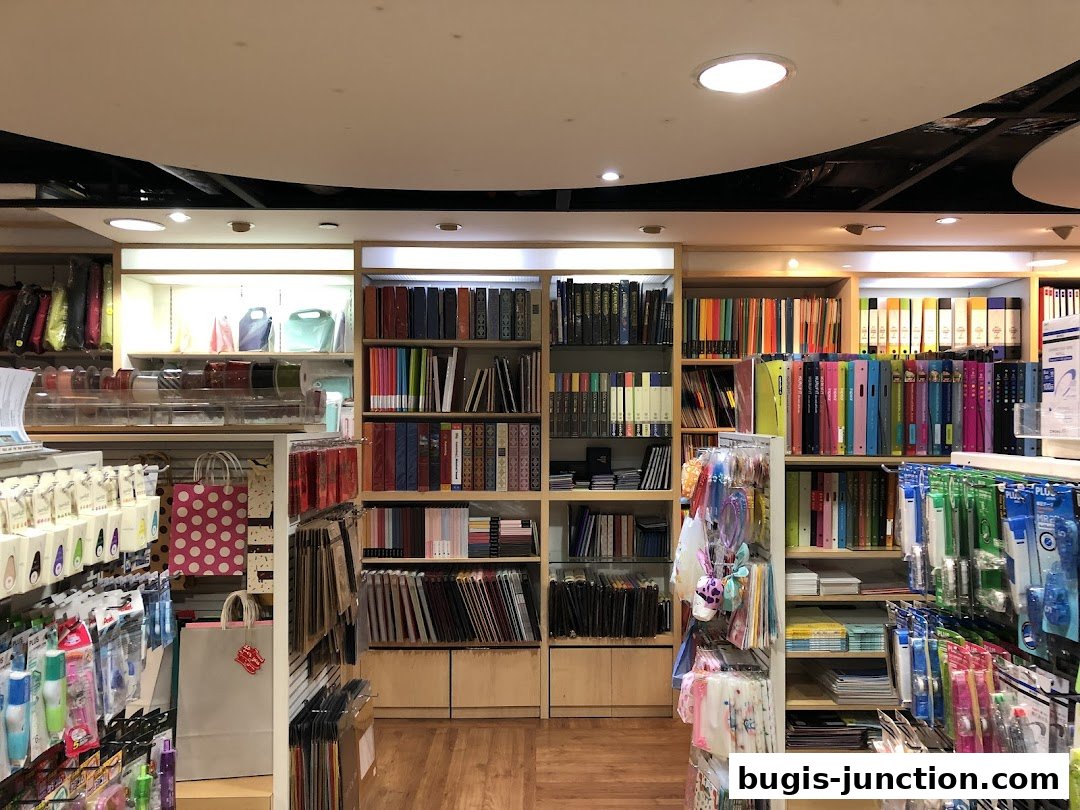 Interior view of a stationery and gift shop with shelves stocked with books, binders, bags, and stationery items.