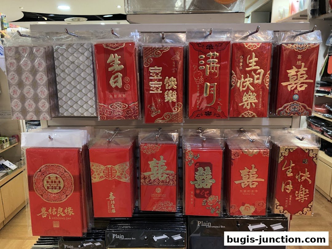 A display of red envelopes and gift wrapping paper for various occasions.