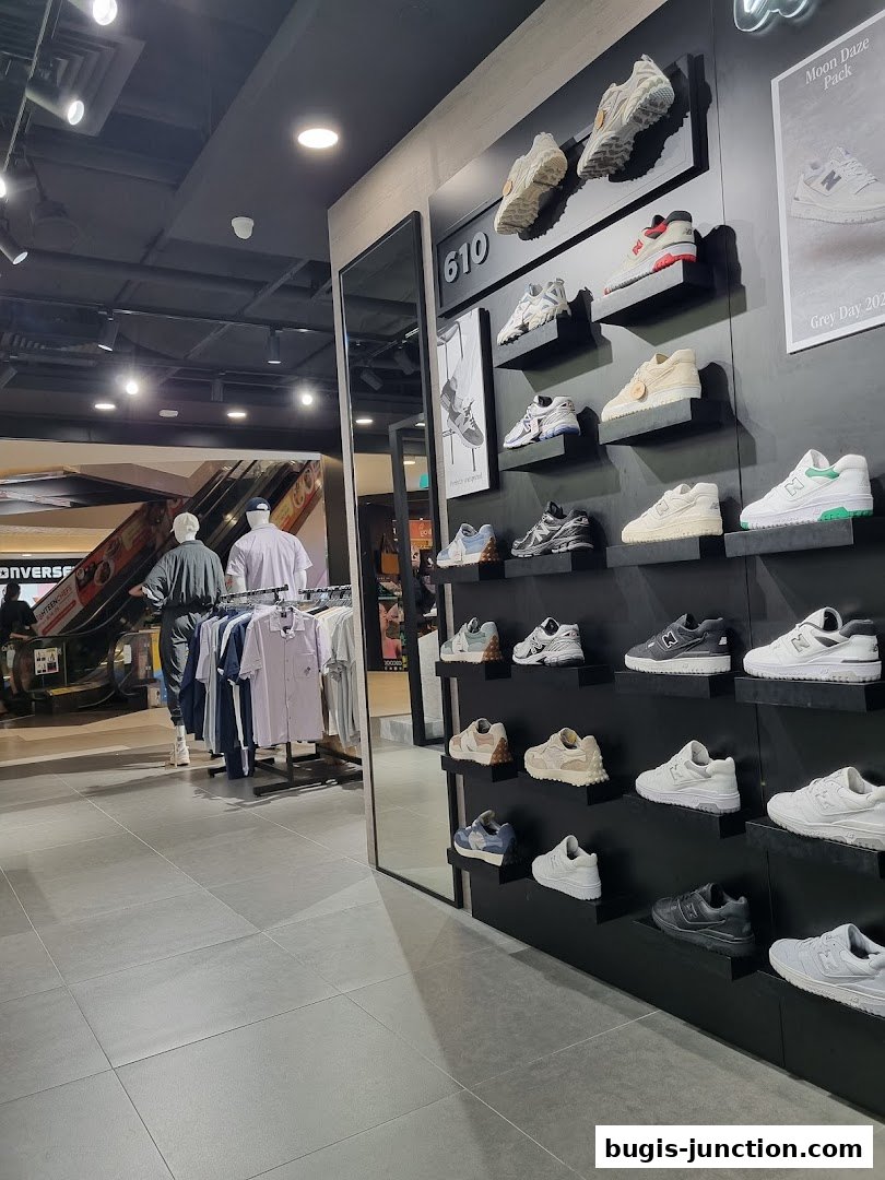 Interior view of a New Balance store showcasing various sneaker models on display shelves.