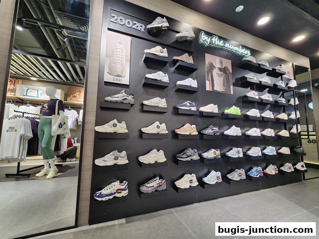 Interior view of a New Balance store showcasing a wide selection of sneakers on display shelves.