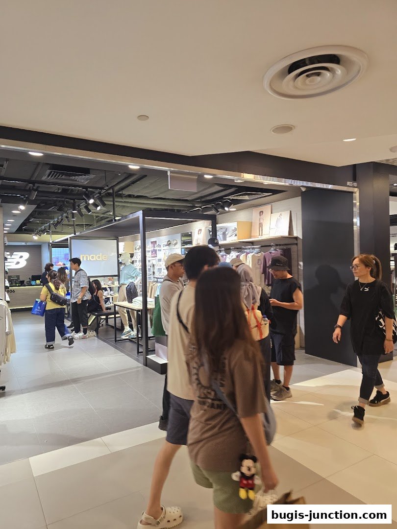 Shoppers browse apparel and footwear inside a New Balance store.