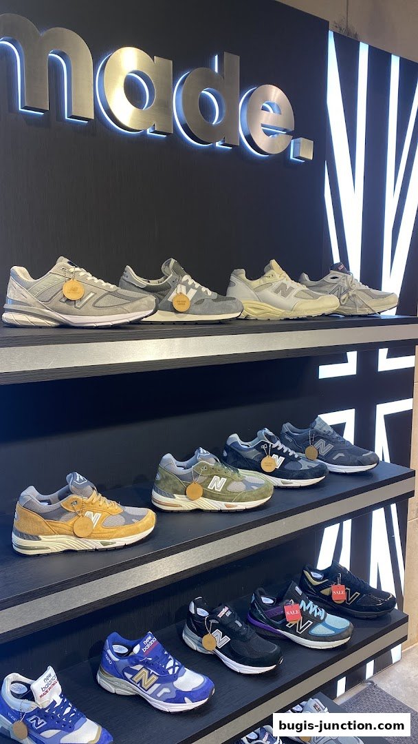 New Balance sneakers displayed on shelves with a 'made.' sign above.