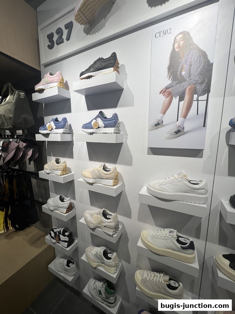 A New Balance store interior showcasing various sneaker models displayed on shelves.