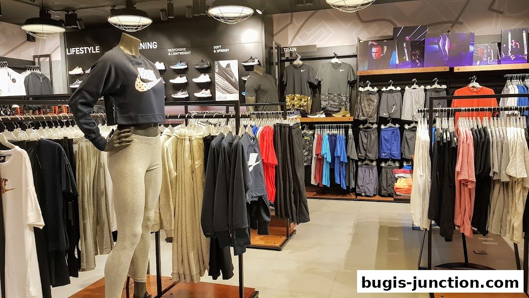 Interior view of a Nike store showcasing athletic apparel and footwear on display.