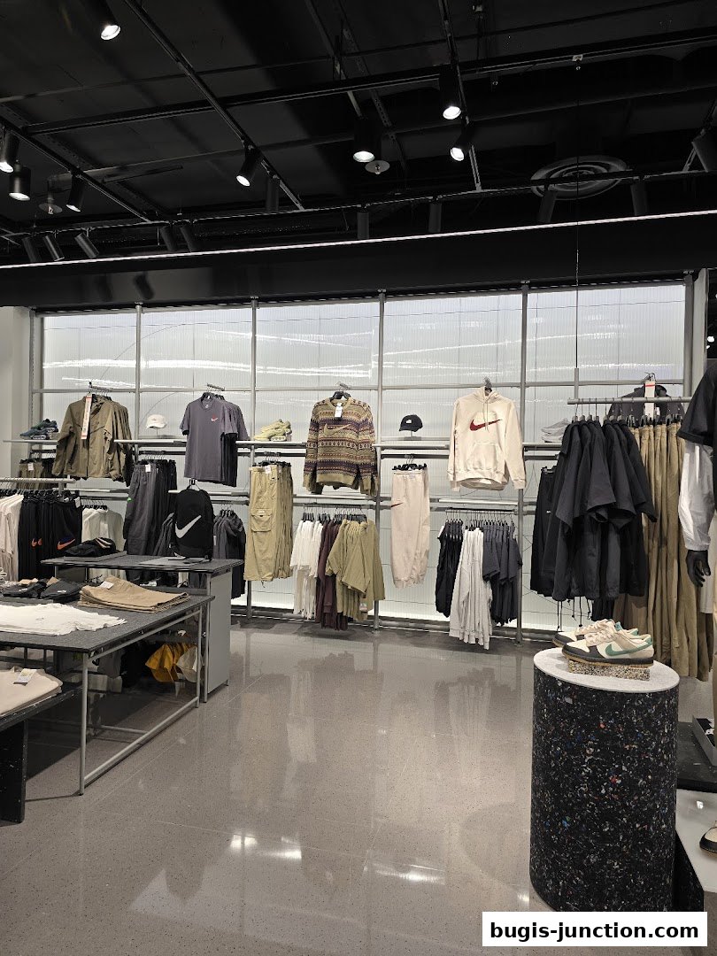 Interior view of a Nike store showcasing apparel and footwear on display racks.
