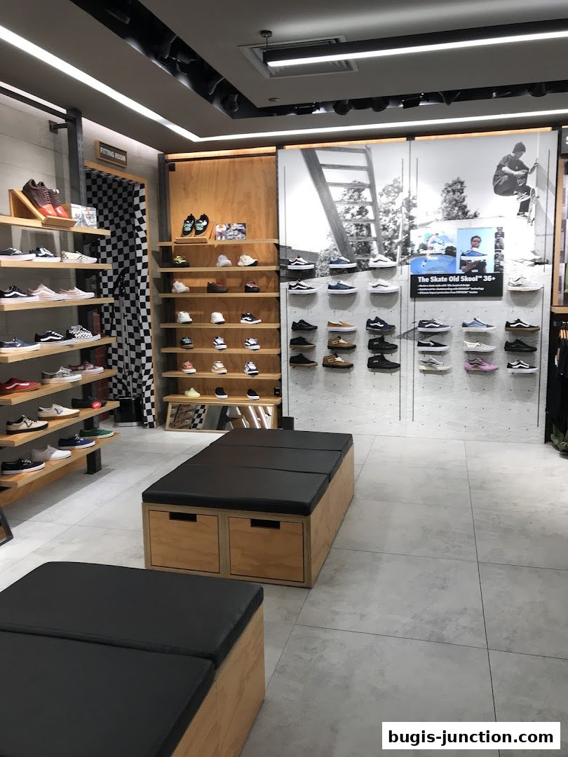 Interior view of a Nike store showcasing various shoe displays and seating areas.
