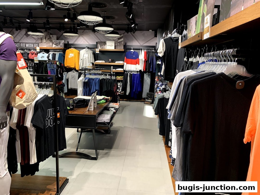 Interior view of a Nike store showcasing athletic apparel and accessories on display racks.
