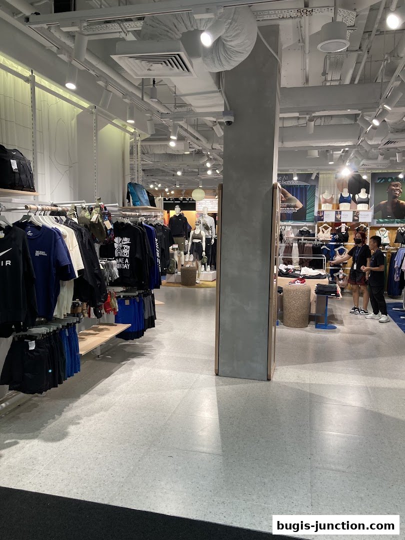 Interior view of a Nike store showcasing apparel and mannequins.
