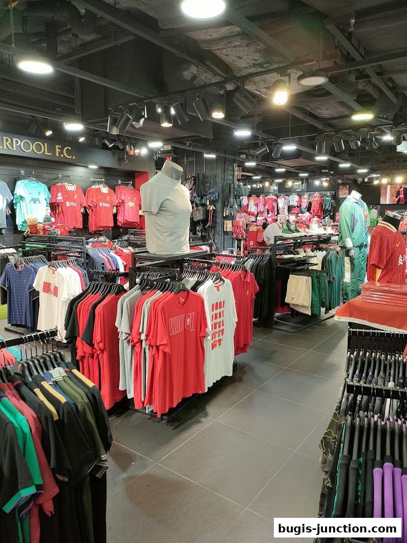 Interior of a Liverpool FC retail store showcasing various team apparel and merchandise.