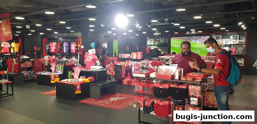 Interior of a Liverpool FC retail store showcasing jerseys, accessories, and merchandise.