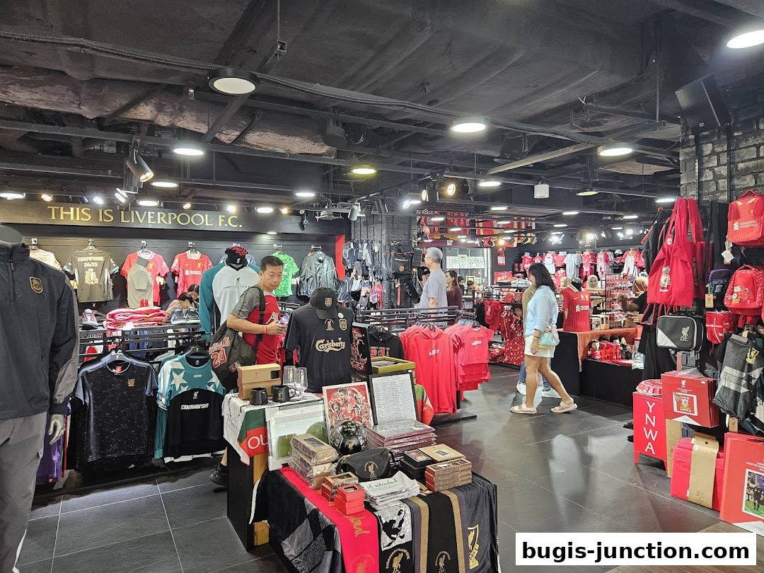 Interior of a Liverpool FC retail store showcasing merchandise and shoppers.