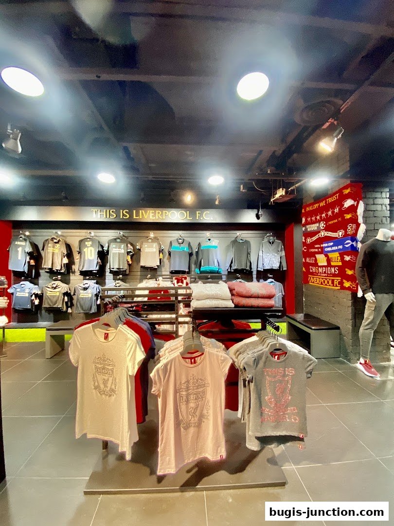 Interior of a Liverpool FC retail store showcasing various team apparel and merchandise.
