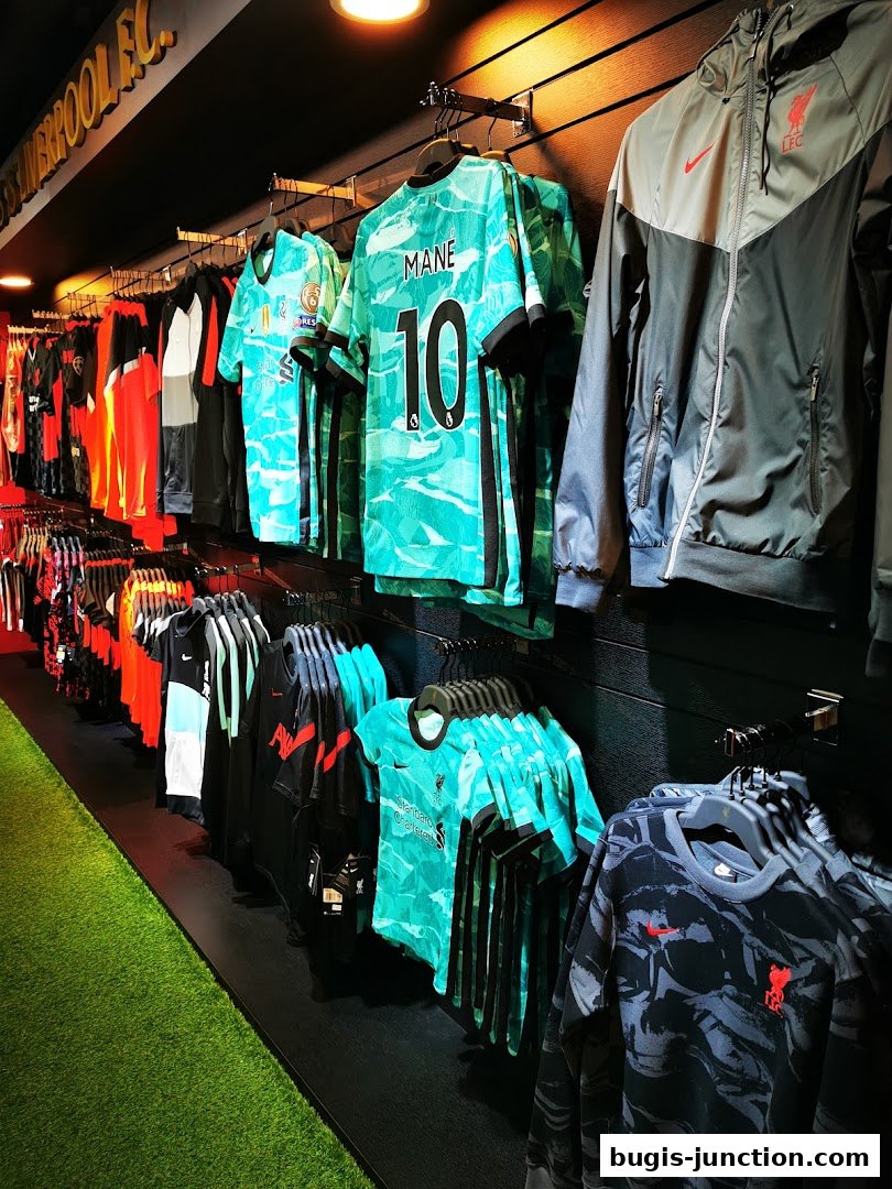 Interior view of a Liverpool FC retail store showcasing jerseys and apparel.