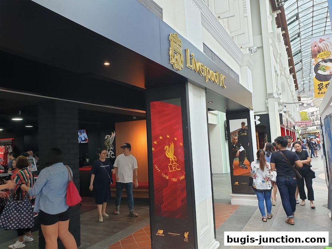 The entrance to the Official Liverpool FC Retail store in Singapore, with people entering and exiting.
