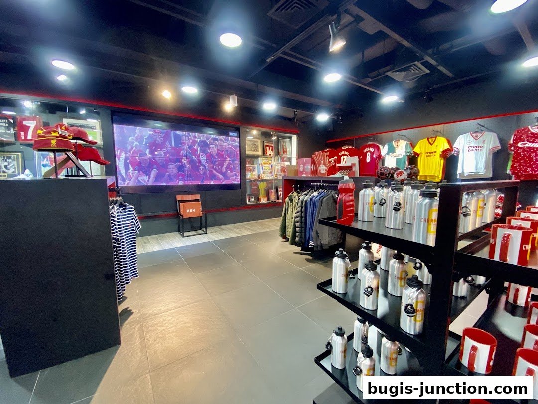 Interior view of the Official Liverpool FC Retail store showcasing merchandise and a large screen.