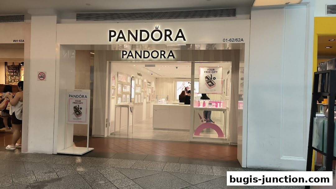 The exterior of a Pandora jewelry store with its signature logo and displays visible inside.