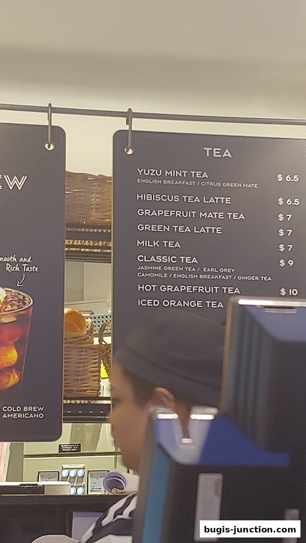 A menu board displaying various tea options and their prices at Paris Baguette.