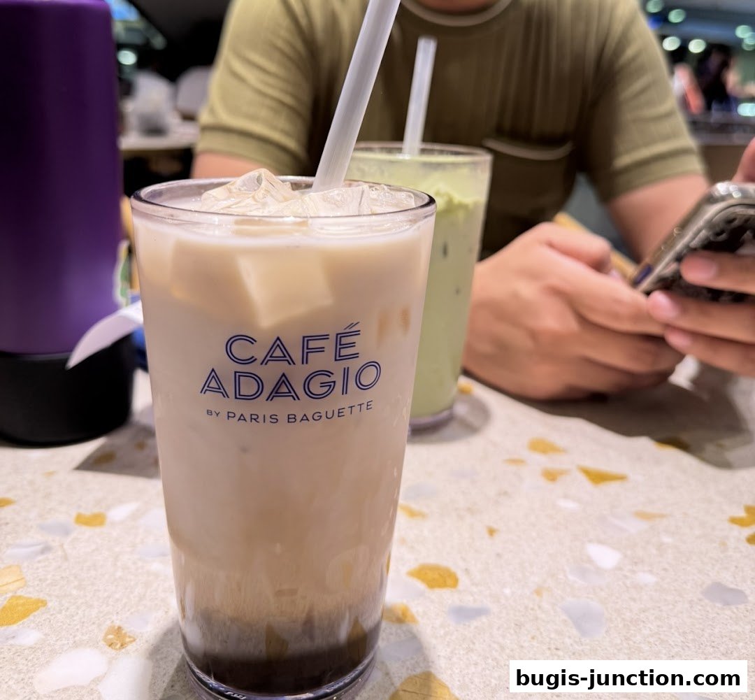 Close-up of two iced drinks on a table, one with 'Cafe Adagio by Paris Baguette' branding.