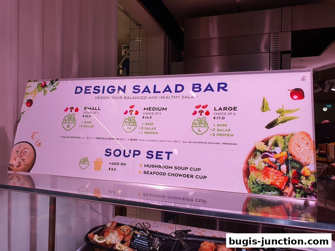 A menu board displaying options for a design salad bar and soup sets.