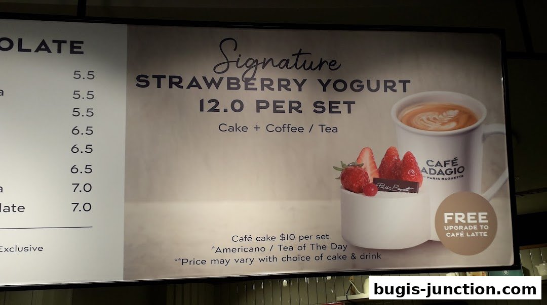 A menu board featuring a signature strawberry yogurt set with cake and coffee/tea.