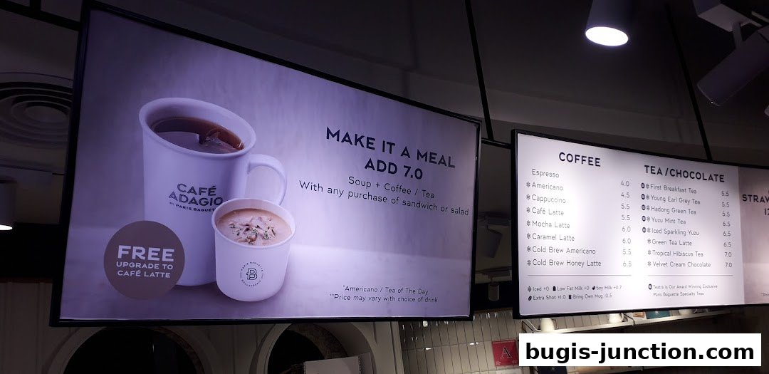 A menu board displaying coffee and tea options, with a promotion for a meal deal.