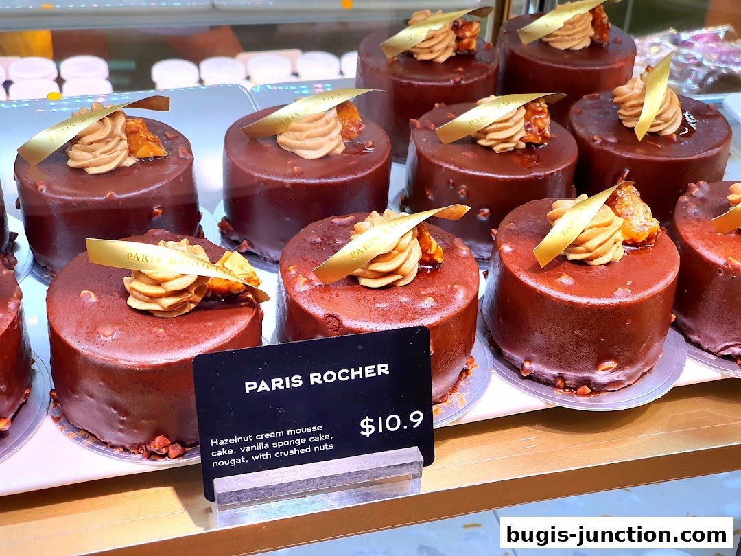 A display of elegant chocolate cakes with hazelnut cream and gold ribbon.