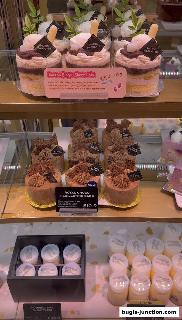 A display of various cakes and puddings from Paris Baguette.