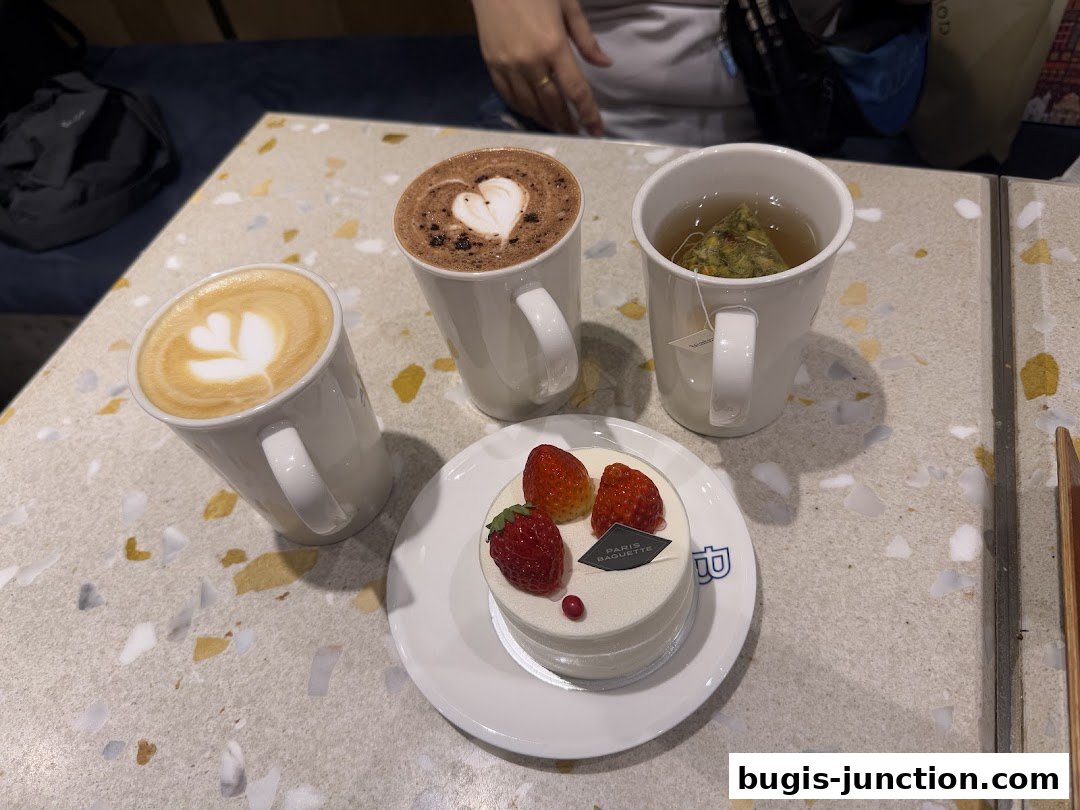 A delightful spread of coffee, tea, and a strawberry cake from Paris Baguette.
