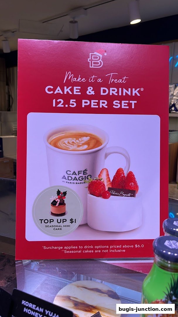 A promotional sign for Paris Baguette featuring a cake and drink set.