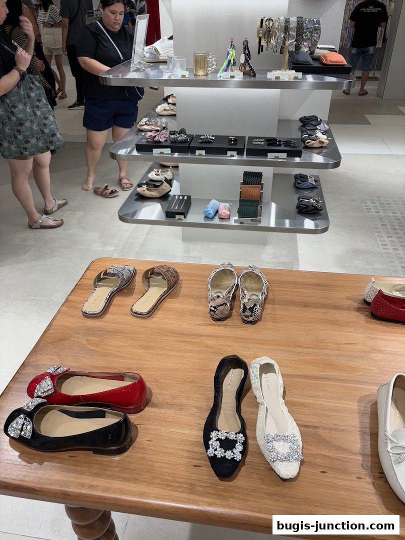 A display of stylish women's shoes and accessories inside a modern retail store.