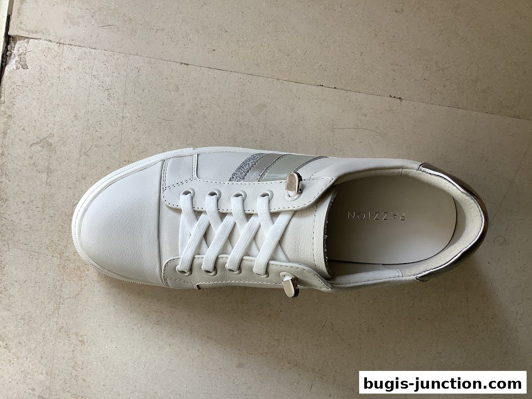 A white leather sneaker with silver accents and white laces, branded PAZZION.