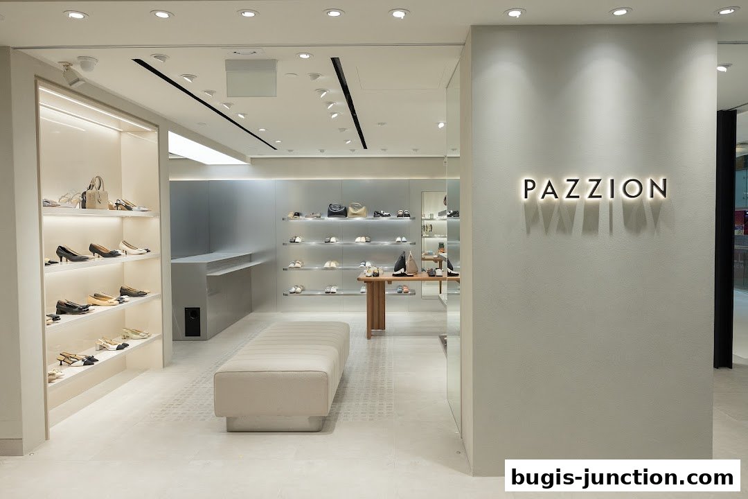 Interior view of a modern shoe store with shelves displaying various footwear and handbags.