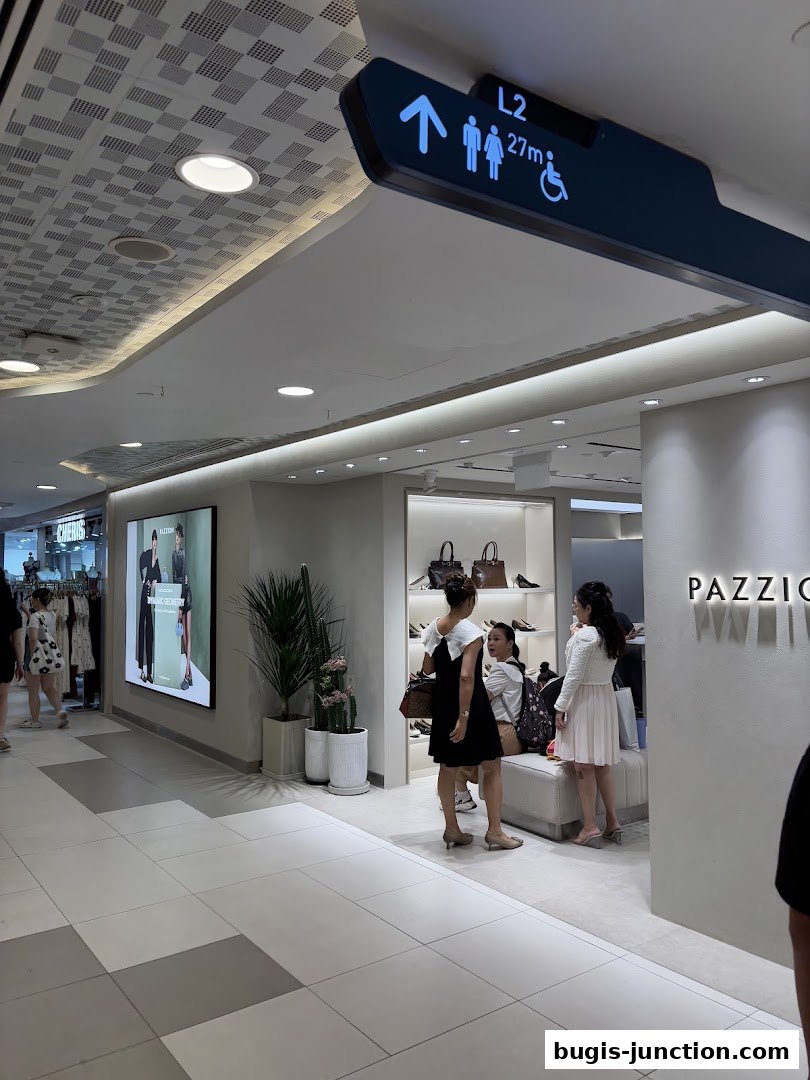 PAZZION Bugis Junction shop interior with customers browsing shoes and handbags.