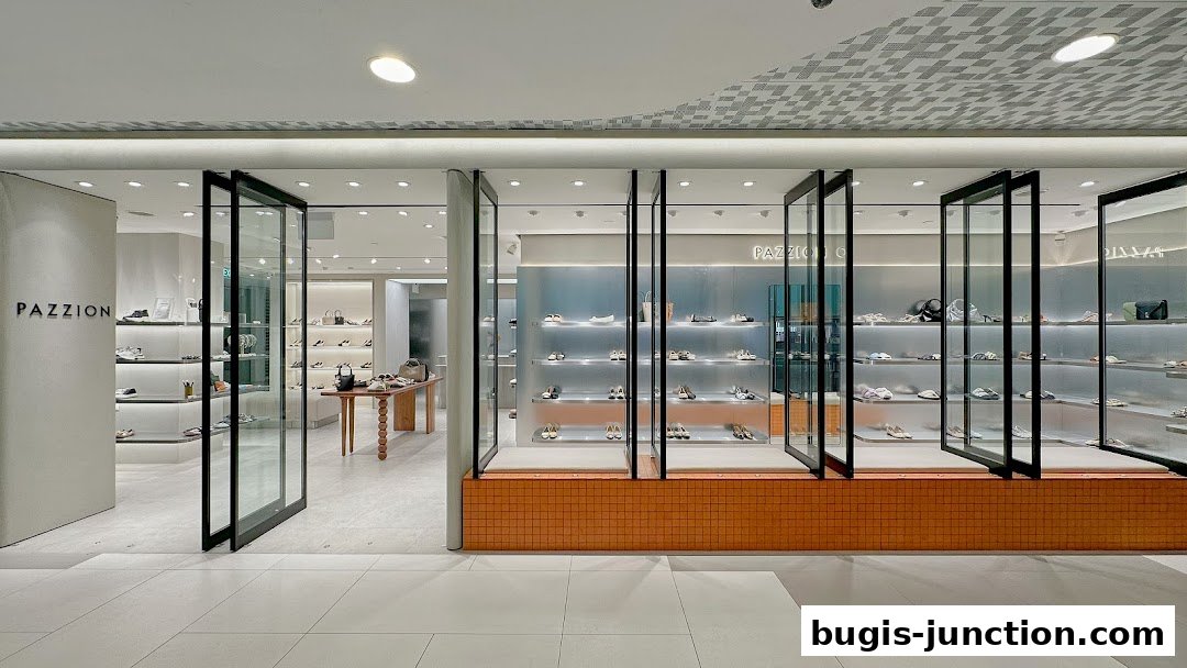 The modern interior of a PAZZION shoe store with display shelves filled with footwear.