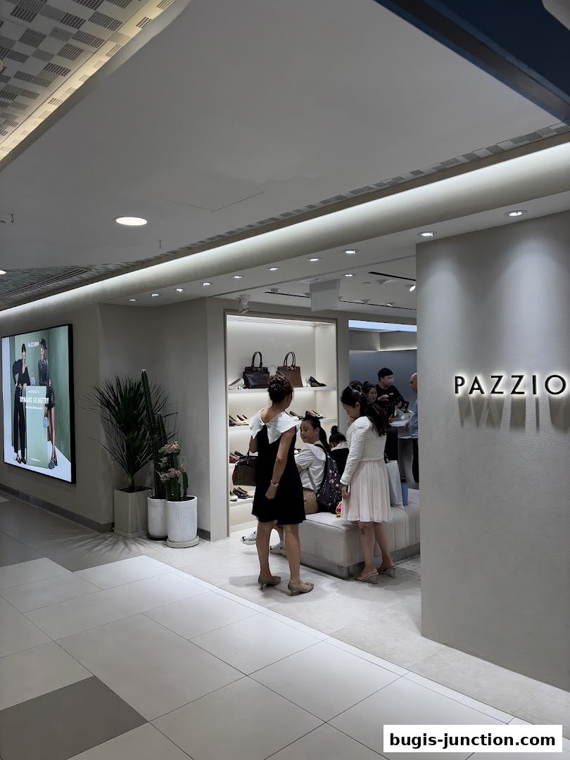 People browsing shoes and handbags inside a PAZZION store.
