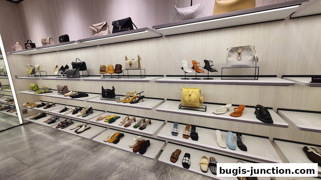 A well-lit shoe and handbag store with shelves displaying various footwear and bags.